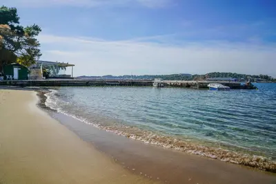 a beach with a pier and the water at Seaside Nestie by BluPine in Athens