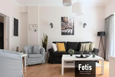 a living room with a couch and a table at Spacious Central Flat in the heart of Athens! in Athens
