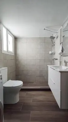 a white bathroom with a toilet and a sink at Spacious Central Flat in the heart of Athens! in Athens