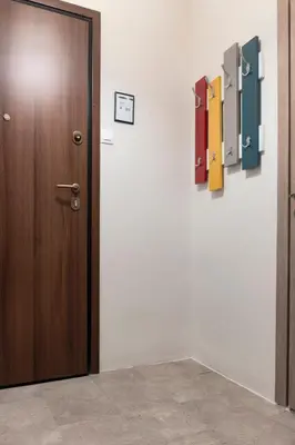 a wooden door in a room with a wall at Spacious Central Flat in the heart of Athens! in Athens