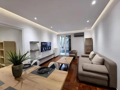 a living room with a couch and a table at Arman Group Lannister in Athens