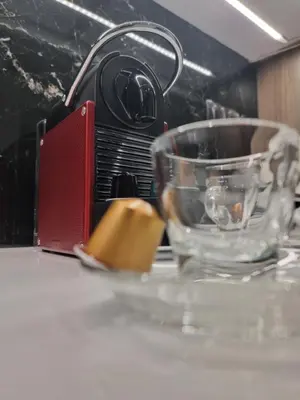 a glass bowl sitting on a table next to a microwave at Arman Group Lannister in Athens