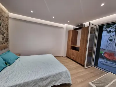 a bedroom with a bed and a large window at Arman Group Lannister in Athens