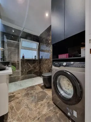 a bathroom with a washing machine and a toilet at Arman Group Lannister in Athens