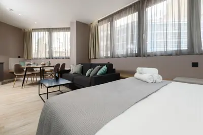 a bedroom with a bed and a living room at Crossroads Athens by YHA in Athens