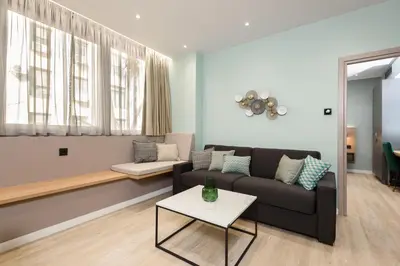 a living room with a couch and a table at Crossroads Athens by YHA in Athens
