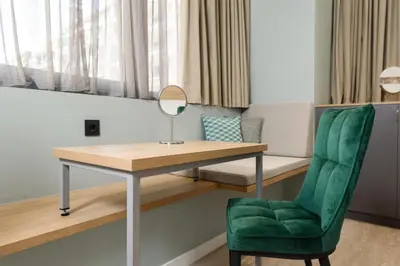 a room with a desk and a chair and a mirror at Crossroads Athens by YHA in Athens