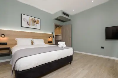 a bedroom with a large bed and a flat screen tv at Crossroads Athens by YHA in Athens