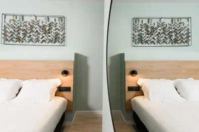 a bedroom with two beds and a mirror at Crossroads Athens by YHA in Athens
