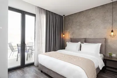a bedroom with a large bed and a balcony at Athenian Spirit in Athens