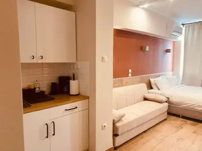 a living room with a white couch and a bed at Monastiraki 506 SuperHost Hub in Athens