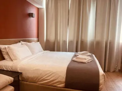 a hotel room with a bed with two towels on it at Monastiraki 506 SuperHost Hub in Athens
