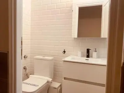 a white bathroom with a toilet and a sink at Monastiraki 506 SuperHost Hub in Athens