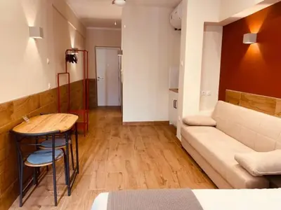 a living room with a couch and a table at Monastiraki 506 SuperHost Hub in Athens