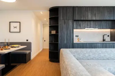 a bedroom with a bed and a desk and a kitchen at 5BD Luxury Penthouse with Sea View in Athens