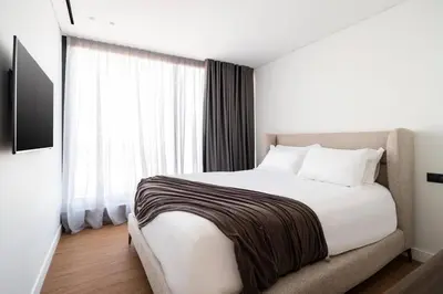 a bedroom with a bed and a large window at 5BD Luxury Penthouse with Sea View in Athens