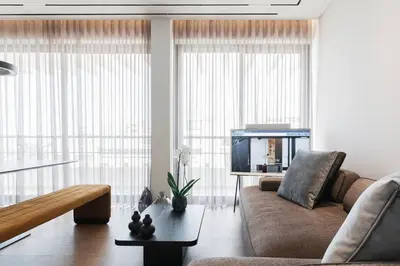 a living room with a couch and a tv at 5BD Luxury Penthouse with Sea View in Athens