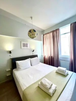 a bedroom with a bed with two towels on it at Monastiraki 106 SuperHost Hub in Athens