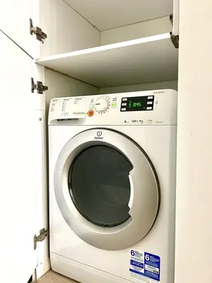 a white washing machine in a room with a shelf at Monastiraki 106 SuperHost Hub in Athens
