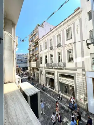 a group of people walking down a street with buildings at Monastiraki 106 SuperHost Hub in Athens