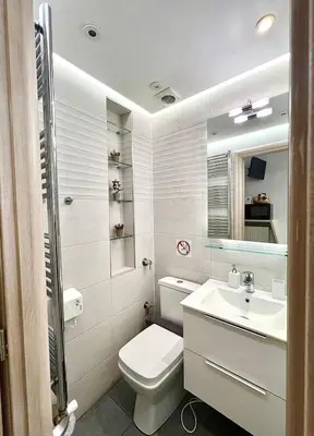 a white bathroom with a toilet and a sink at Monastiraki 106 SuperHost Hub in Athens