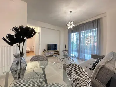 a living room with a couch and a table at Athenean Modern Escape near Marina Flisvos in Athens