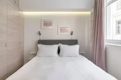 a white bed with white pillows in a bedroom at Monastiraki 107 SuperHost Hub in Athens