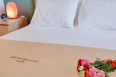 a white bed with flowers on the side of it at Monastiraki 212 - 43m2 SuperHost Hub in Athens