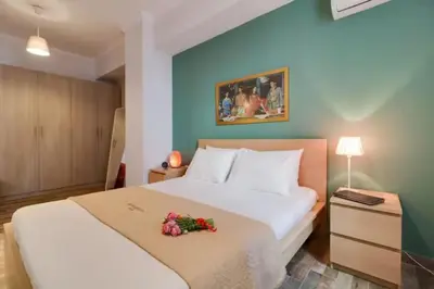 a bedroom with a large white bed with flowers on it at Monastiraki 212 - 43m2 SuperHost Hub in Athens