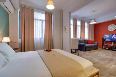 a bedroom with a large bed and a living room at Monastiraki 212 - 43m2 SuperHost Hub in Athens