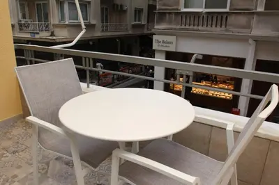 a white table and two chairs on a balcony at Adri & Marg luxury living in Athens