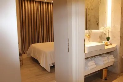a bathroom with a sink and a mirror and a bed at Adri & Marg luxury living in Athens