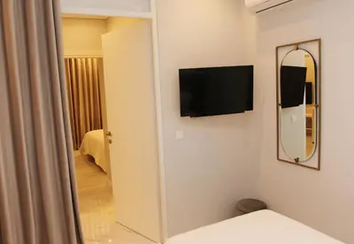 a room with a mirror and a tv on a wall at Adri & Marg luxury living in Athens