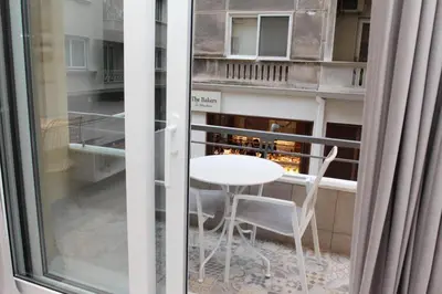 a room with a window with a table and a chair at Adri & Marg luxury living in Athens