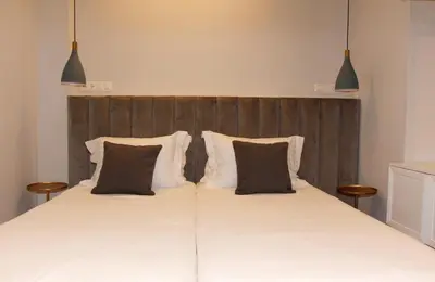a bedroom with a large bed with two pillows at Adri & Marg luxury living in Athens