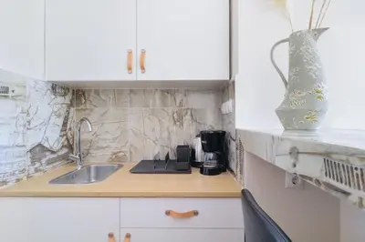 a kitchen counter with a sink and a vase at Monastiraki 507 SuperHost Hub in Athens