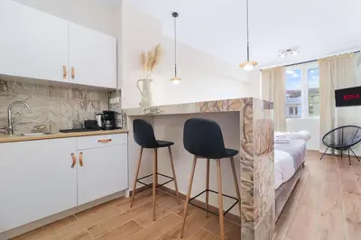 a kitchen with two chairs and a bed in a room at Monastiraki 507 SuperHost Hub in Athens