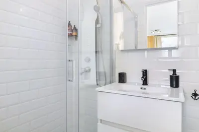a white bathroom with a sink and a shower at Monastiraki 507 SuperHost Hub in Athens