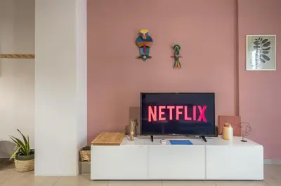 a tv sitting on top of a white cabinet at Confy Living Apartment Metaxourghio Metro Station in Athens