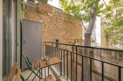 a balcony with a bench and a brick wall at Confy Living Apartment Metaxourghio Metro Station in Athens