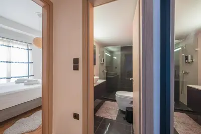 a bathroom with a toilet and a sink at Confy Living Apartment Metaxourghio Metro Station in Athens