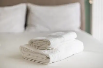 a pile of white towels sitting on a table at Confy Living Apartment Metaxourghio Metro Station in Athens