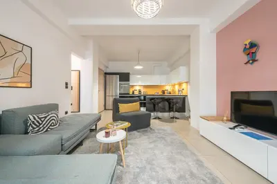 a living room with a couch and a tv at Confy Living Apartment Metaxourghio Metro Station in Athens