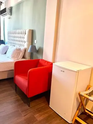 a living room with a red couch and a bed at Monastiraki 508 Central Suite in Athens
