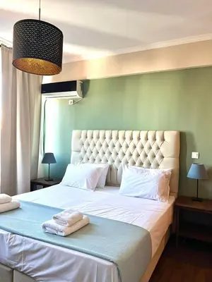 a bedroom with a large bed with two towels on it at Monastiraki 508 Central Suite in Athens