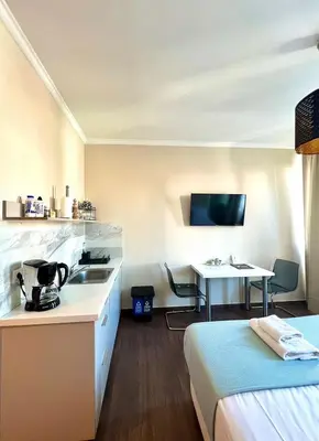 a hotel room with a bed and a kitchen and a table at Monastiraki 508 Central Suite in Athens