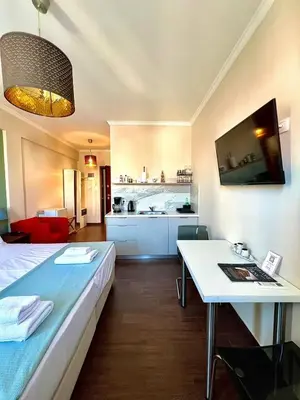 a room with a bed and a table and a kitchen at Monastiraki 508 Central Suite in Athens