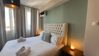 a bedroom with a large white bed with a window at Monastiraki 509 Central Suite in Athens