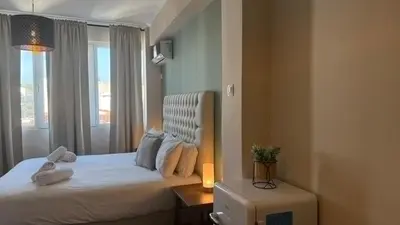 a bedroom with a white bed with a window at Monastiraki 509 Central Suite in Athens