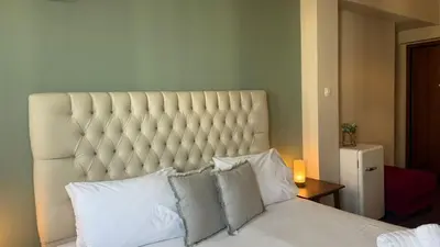 a bedroom with a large white bed with pillows at Monastiraki 509 Central Suite in Athens